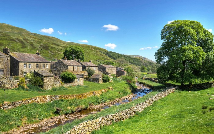 Stone houses by a stream in the United Kingdom