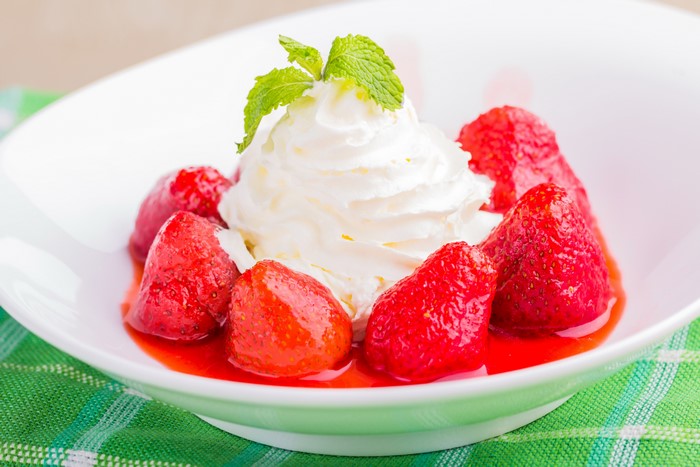 Strawberries with whipped cream and mint