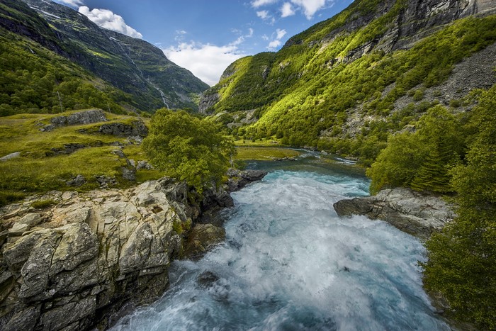 River flowing through a green mountain valley in Norway