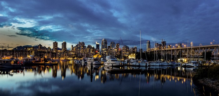 Vancouver skyline and marina at dusk with bridge