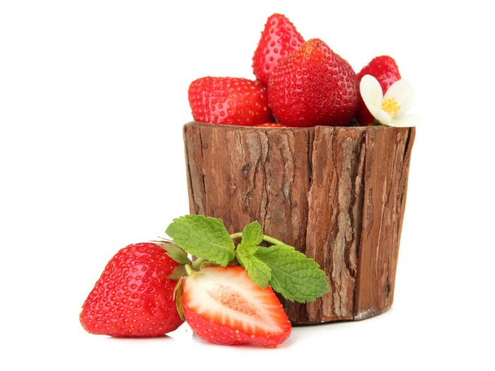 Strawberries in a wooden container with mint leaves