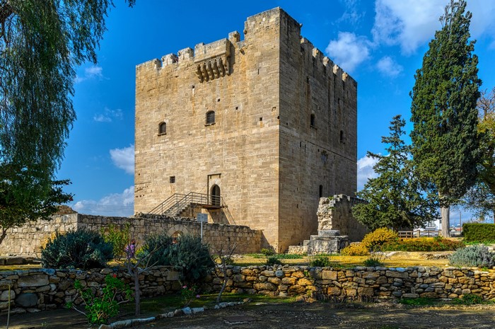 Kolossi Castle in Cyprus with trees and blue sky
