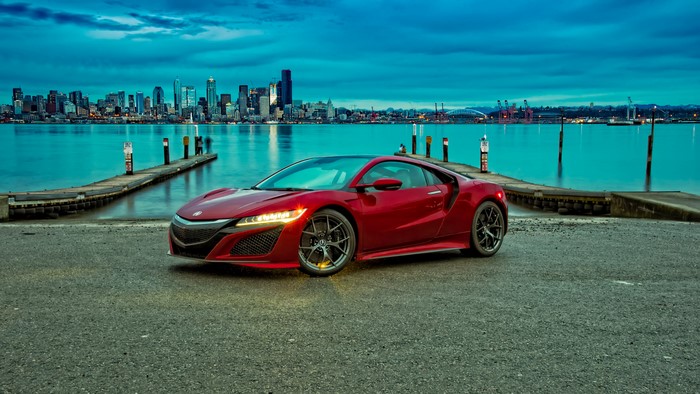 Red 2016 Acura NSX by the water with city skyline
