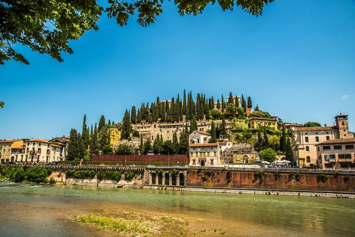 Verona, Italy cityscape with river and cypress trees
