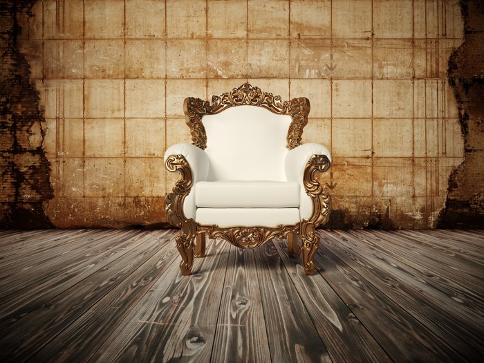 Luxury armchair on wooden floor with textured wall