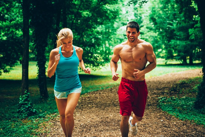 Man and woman running in a forest