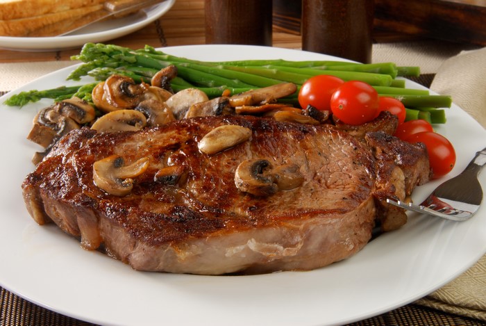 Steak with Mushrooms, Asparagus, and Tomatoes on a Plate