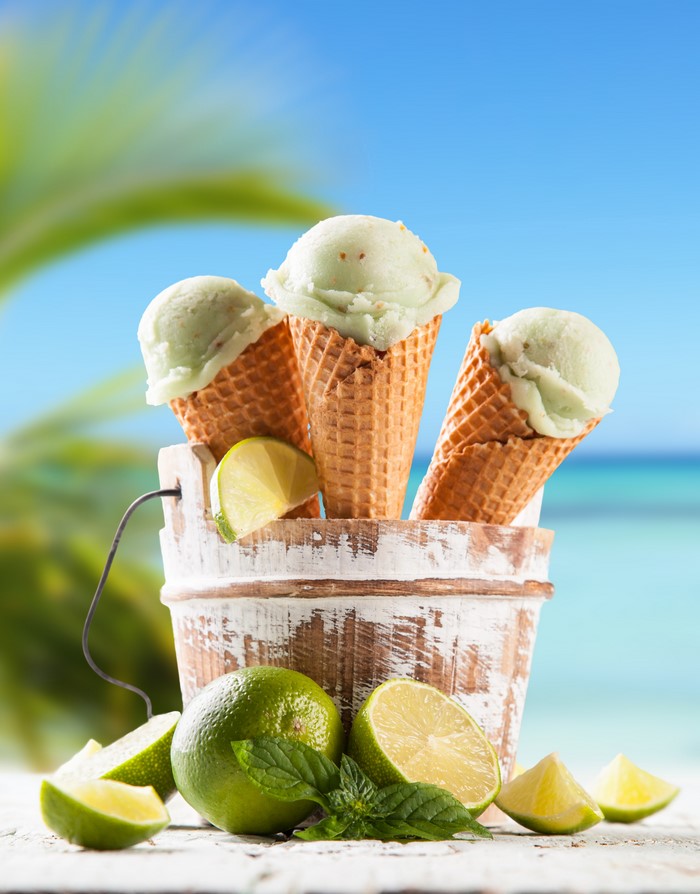 Lime ice cream cones in a bucket with limes and mint