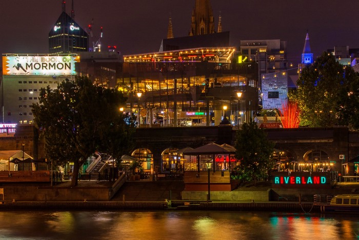 Riverland sign and buildings at night in Melbourne