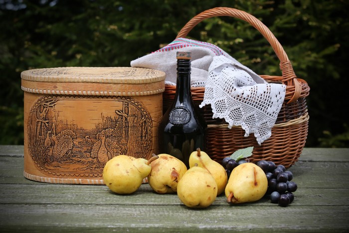 Still-life with pears, grapes, bottle, and wicker basket