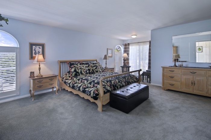 Bedroom with bed, dresser, and lamps