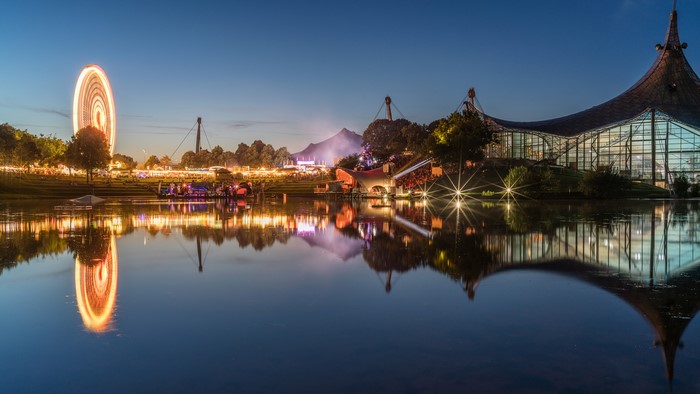 Olympiapark Munich at dusk with Ferris wheel and reflection