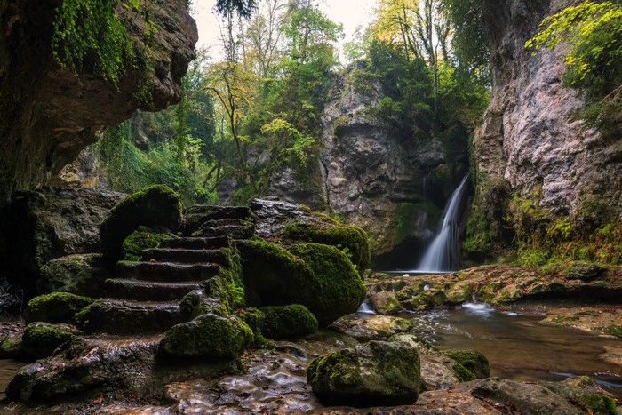 Mossy Stone Stairs by Waterfall in Switzerland