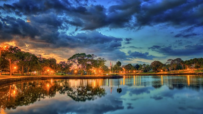Evening scene with street lights reflecting in a pond in Tarpon Springs, Florida