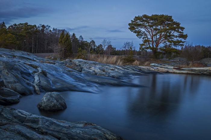 Rocky coast and lake at dusk in Sweden