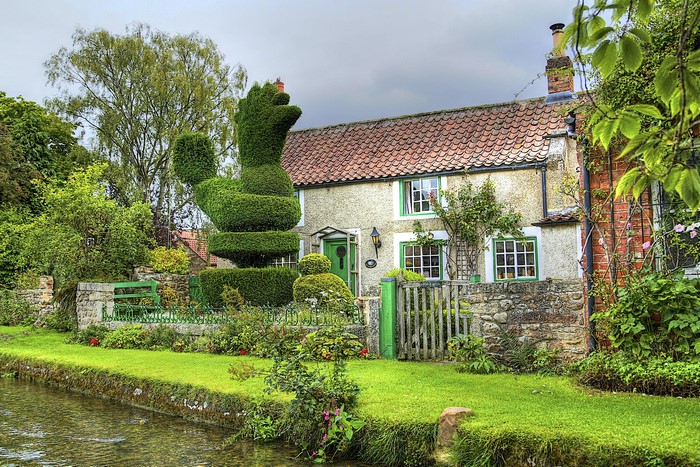 Topiary duck in front of a cottage in Bishop Monkton, England