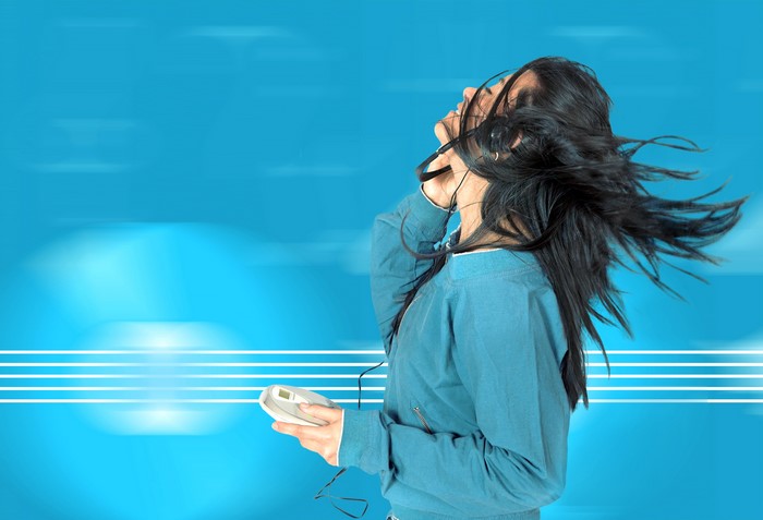 Brunette girl with headphones listening to music