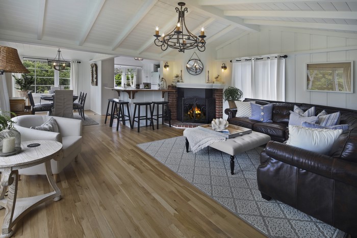 Living room with chandelier, sofa, and armchair