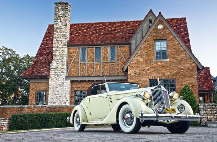 1936 Packard Twelve Coupe Roadster in front of a brick house