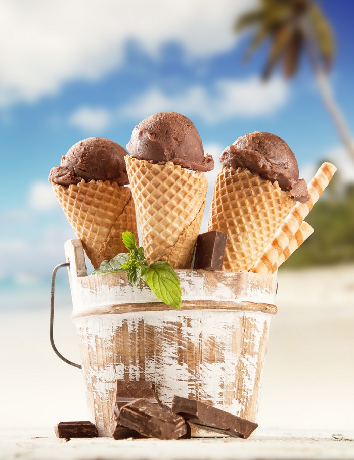 Chocolate ice cream cones in a bucket on a beach