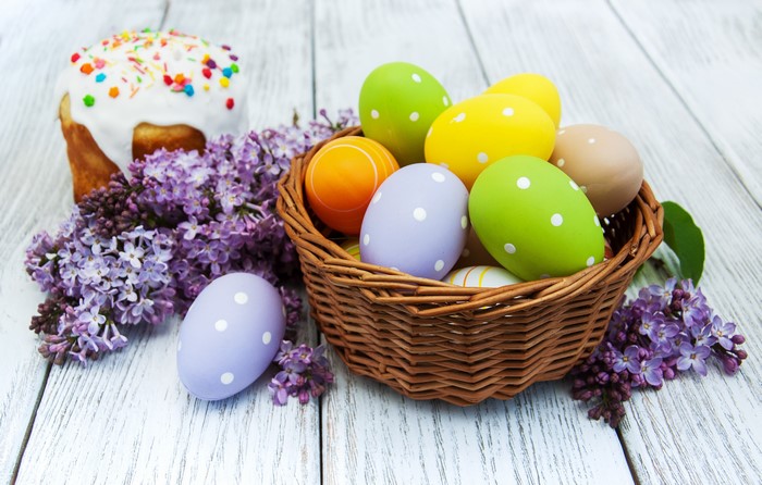 Easter cake and eggs in a basket with lilacs