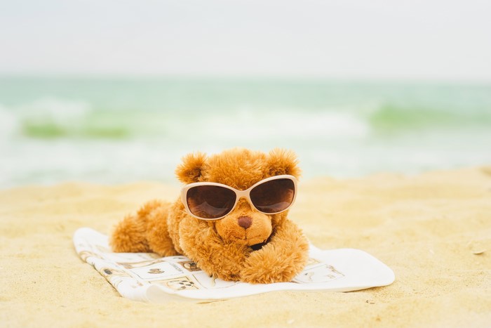 Teddy bear with sunglasses on the beach