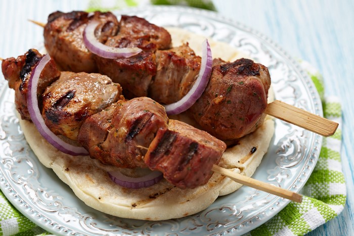 Shashlik skewers with red onion on a plate