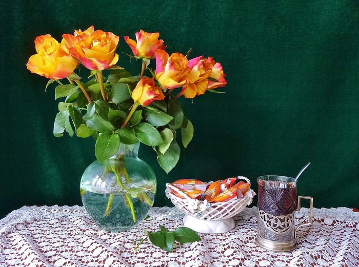 Still-life with roses, tea, and candy