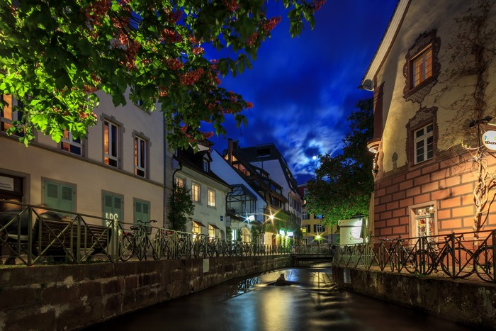 Evening canal in Freiburg, Germany with houses and trees
