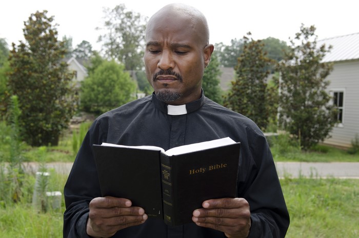 Father Gabriel Stokes from The Walking Dead reading the Holy Bible
