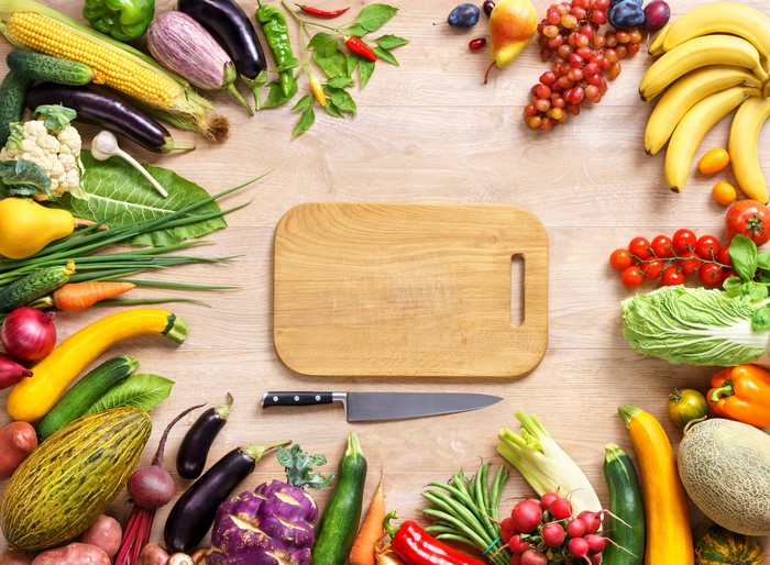 Vegetables and knife on cutting board