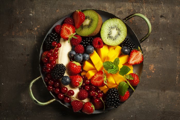 Fruit platter with strawberries, kiwi, mango, and berries