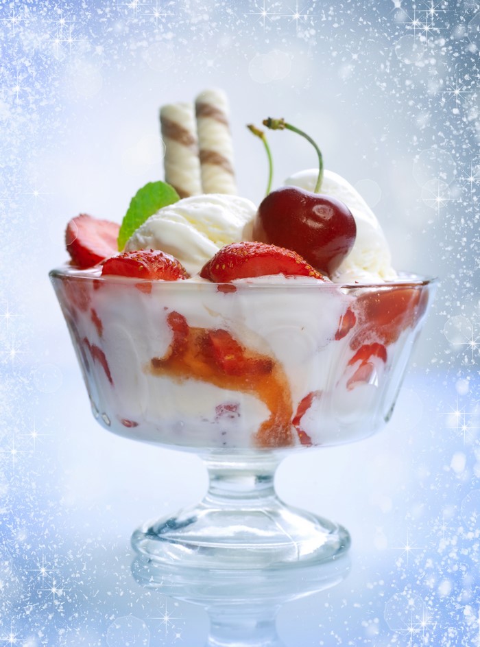Ice cream sundae with strawberries and cherries