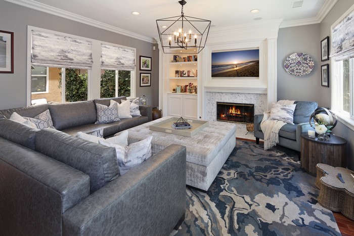 Living room with sectional sofa, fireplace, and chandelier
