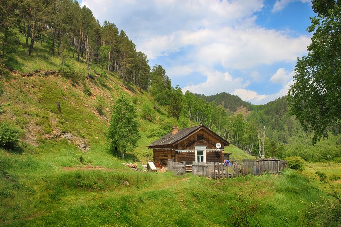 Wooden house in a green forest near Baikal, Russia