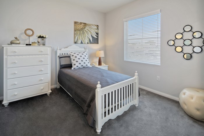 Children's bedroom with white bed and dresser