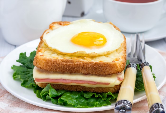 Croque Madame sandwich with fried egg and tea