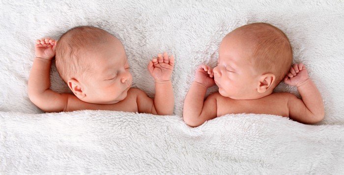 Two Newborn Babies Sleeping on White Blanket