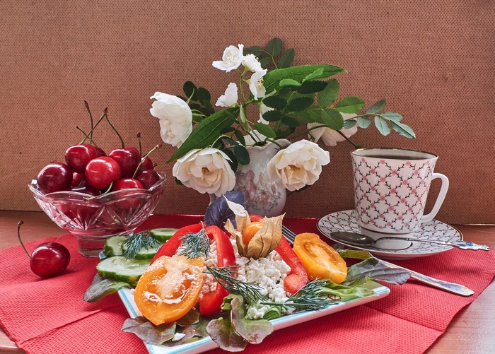 Still life with cherries, salad, and coffee