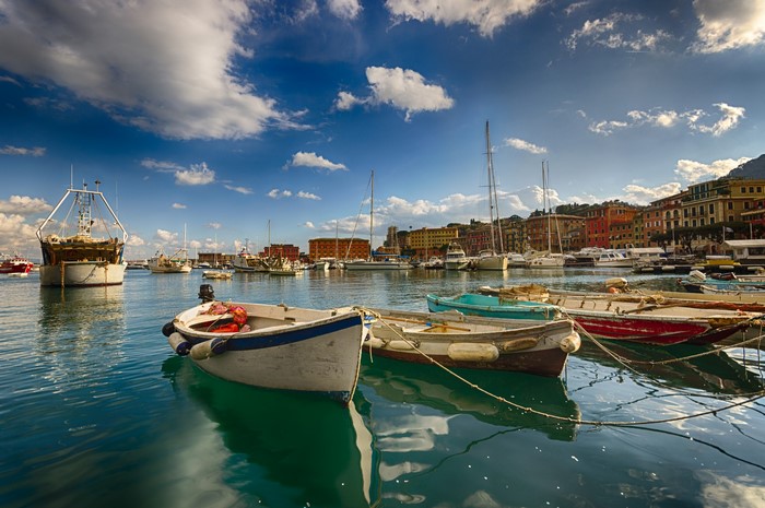 Boats docked in a harbor with colorful buildings in Santa Margherita, Liguria, Italy