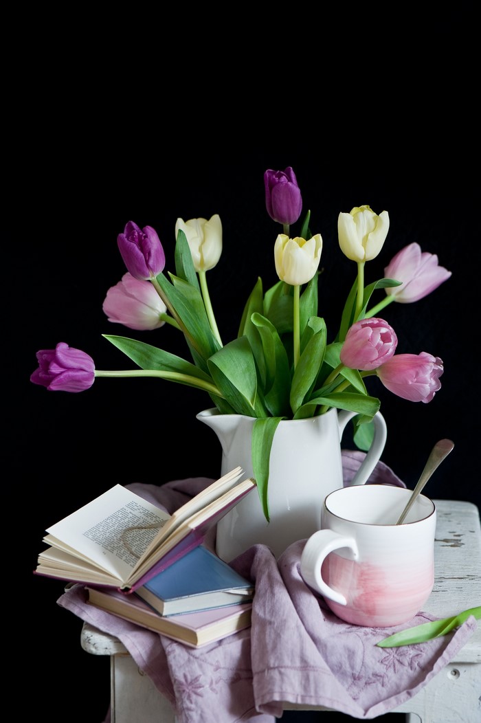 Still life with tulips, cup, and books