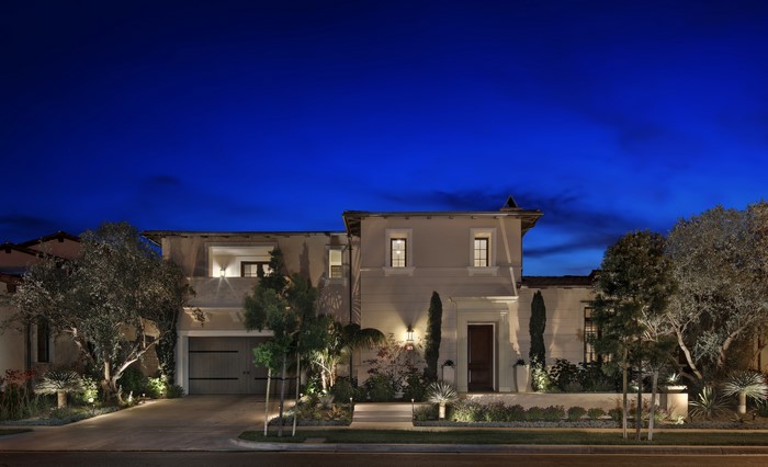 Luxury Mansion with Garage and Trees at Night