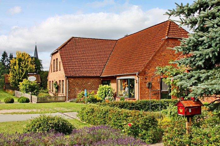 Brick house with red tile roof in Leussow, Germany