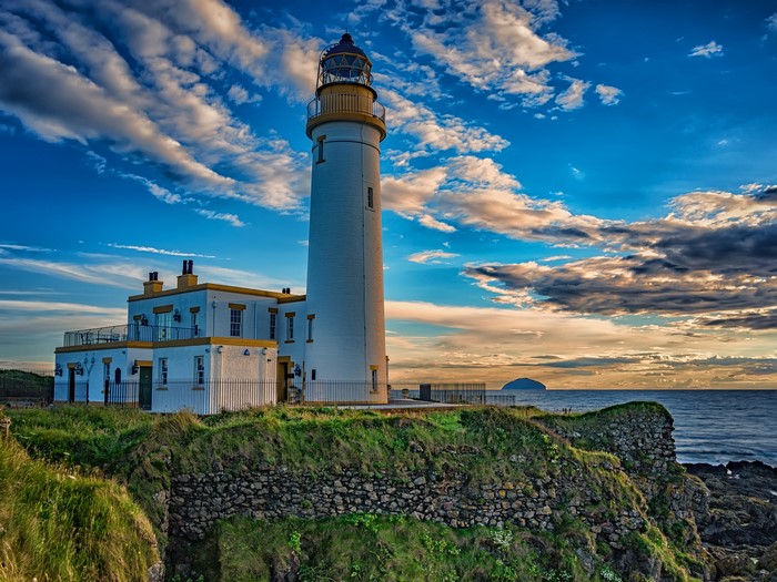 Lighthouse on a cliff overlooking the sea