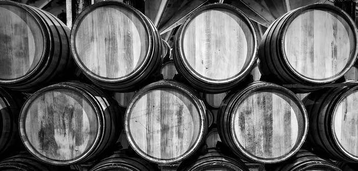 Stacked wooden barrels in black and white