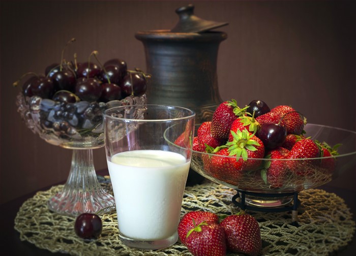 Still life with strawberries, cherries, and milk