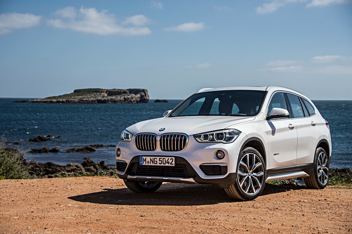 White BMW X1 F48 parked by the sea