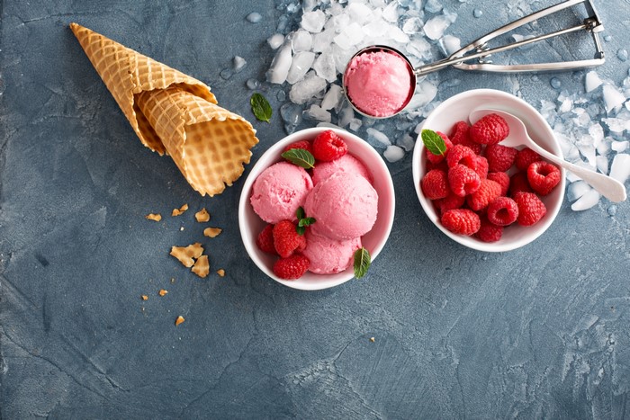 Raspberry ice cream with cones and berries