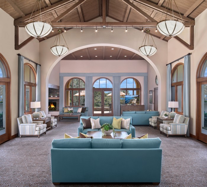 Living room with sofas, armchairs, and chandeliers