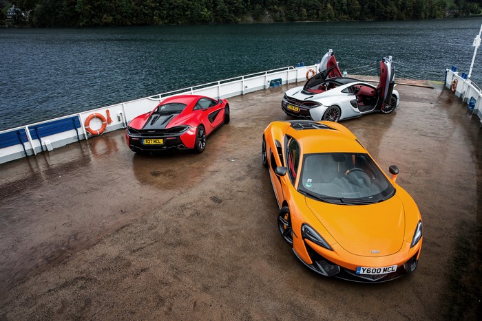 Three McLaren sports cars on a ferry